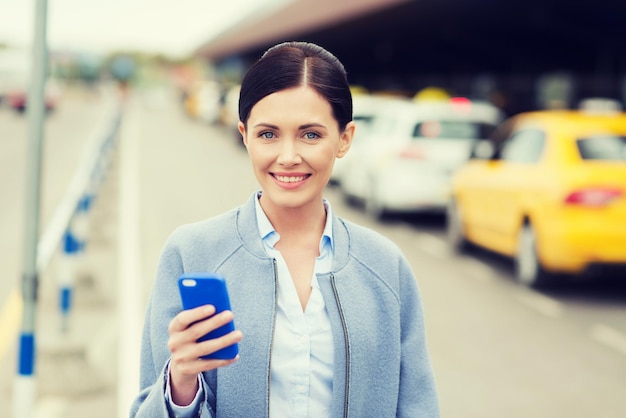 travel business trip people tourism concept smiling young woman with smartphone taxi station city street 380164 130039